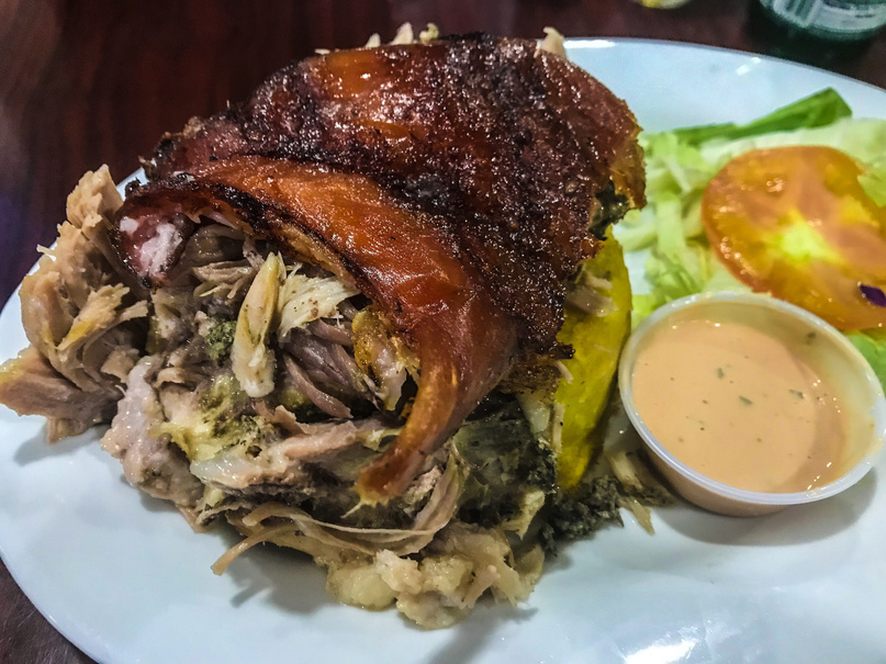 Plate of Pernil with Mofongo and salad, a traditional Puerto Rican dish